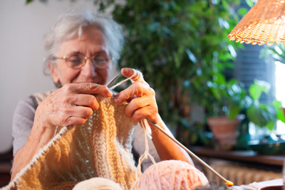 image of senior woman knitting