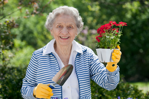 image of independent living resident with flowers